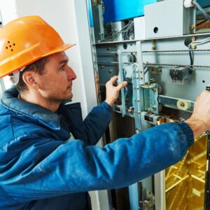 Maintenance worker inspecting utility panel